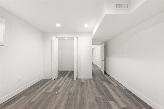 unfurnished bedroom with dark wood finished floors, recessed lighting, a closet, visible vents, and baseboards