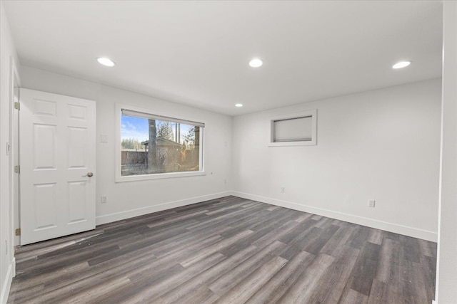 spare room with dark wood-style floors, baseboards, and recessed lighting