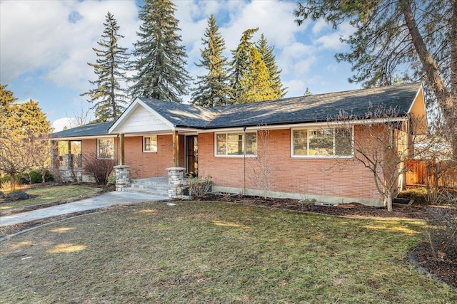 single story home featuring a front lawn and brick siding