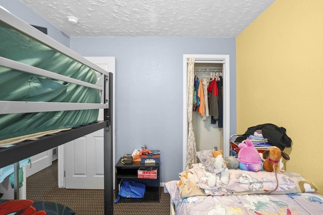 carpeted bedroom featuring a closet and a textured ceiling