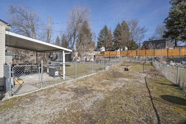 view of yard featuring fence and a gate