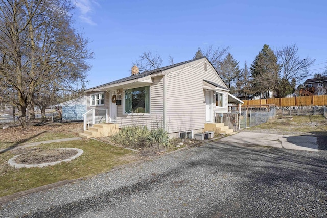 view of front of property with fence and a chimney