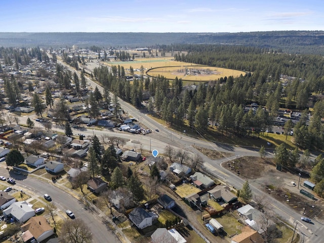 birds eye view of property featuring a wooded view