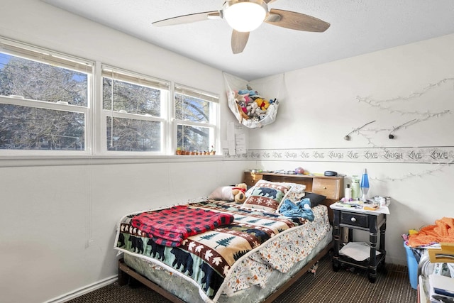 bedroom with ceiling fan and carpet flooring