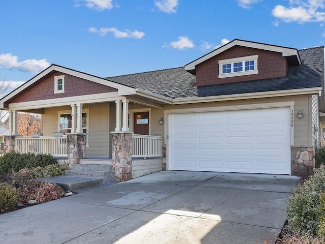 craftsman-style home featuring a porch, stone siding, driveway, and a shingled roof