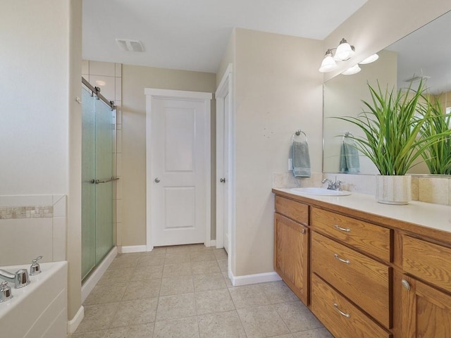 full bath with a stall shower, baseboards, tile patterned floors, a garden tub, and vanity