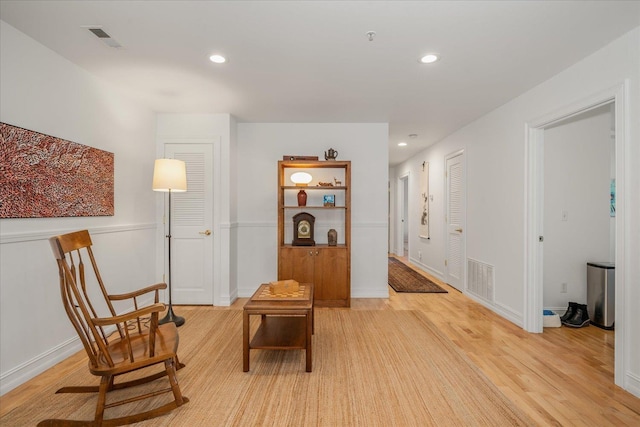 living area featuring light wood-style flooring, visible vents, and recessed lighting