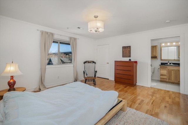 bedroom with visible vents, an inviting chandelier, light wood-style floors, ornamental molding, and a sink