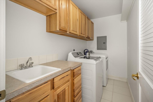 laundry room featuring cabinet space, light tile patterned floors, electric panel, independent washer and dryer, and a sink