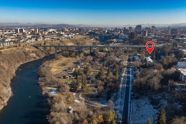 bird's eye view featuring a view of city and a water and mountain view
