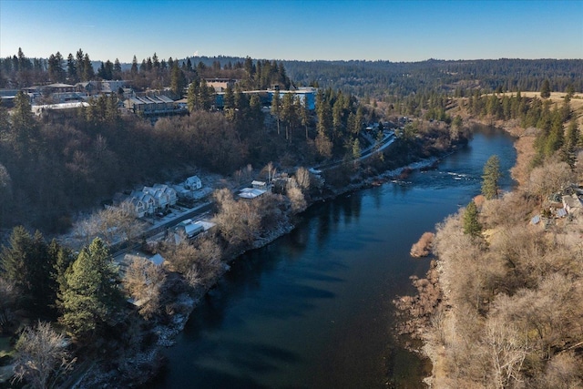 aerial view with a forest view and a water view