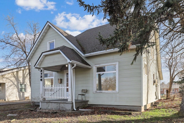 view of front of home with a porch and roof with shingles