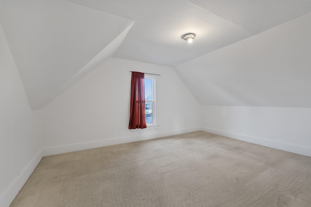 bonus room featuring carpet flooring, vaulted ceiling, and baseboards