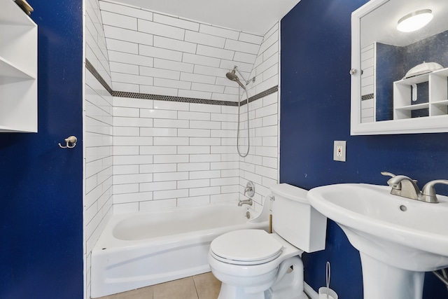 full bath featuring shower / washtub combination, tile patterned flooring, a sink, and toilet