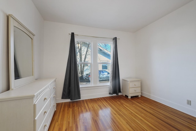 interior space featuring light wood-type flooring and baseboards