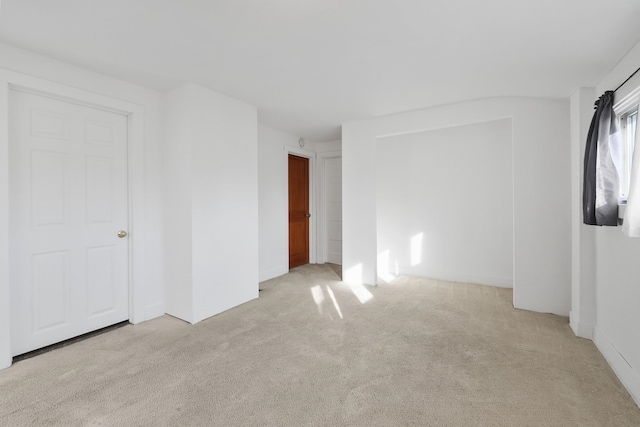 unfurnished bedroom with light colored carpet