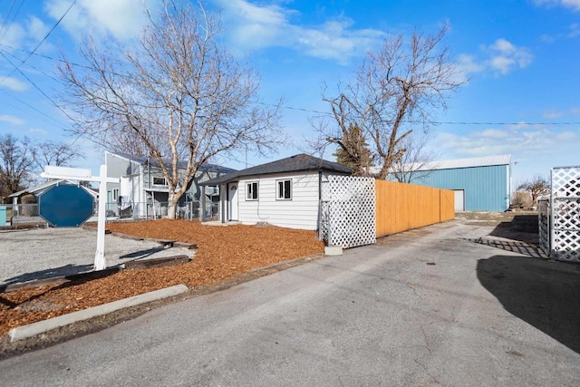 view of front of home with an outbuilding and fence