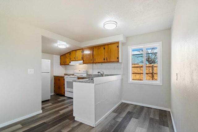 kitchen featuring white appliances, baseboards, dark wood-style flooring, and backsplash