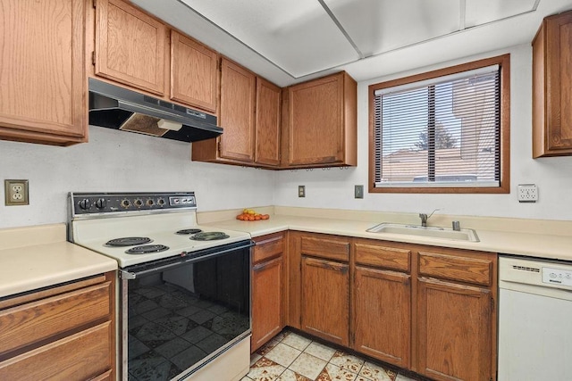 kitchen featuring light countertops, white appliances, a sink, and under cabinet range hood