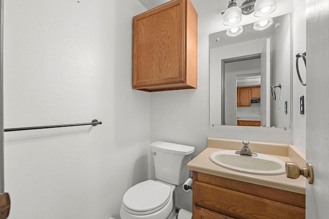 bathroom with toilet and vanity