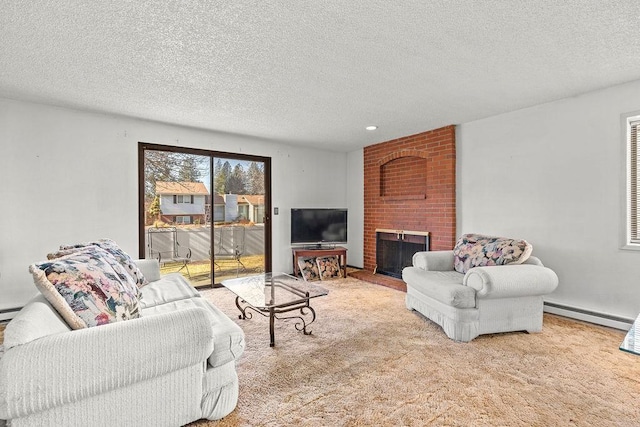 living area with a baseboard heating unit, a textured ceiling, a brick fireplace, and carpet