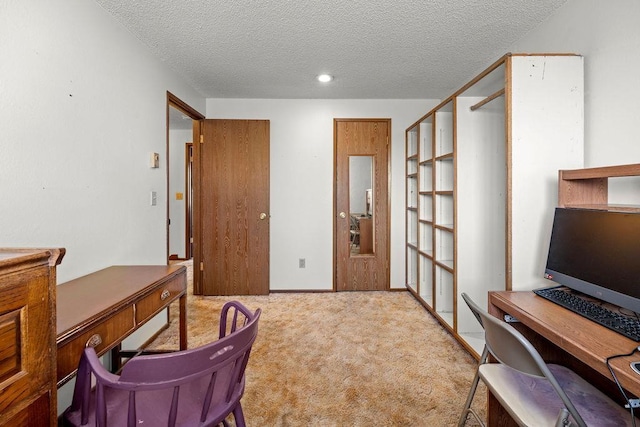 carpeted office space featuring a textured ceiling and baseboards