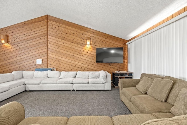 living room featuring vaulted ceiling, carpet floors, wood walls, and a textured ceiling