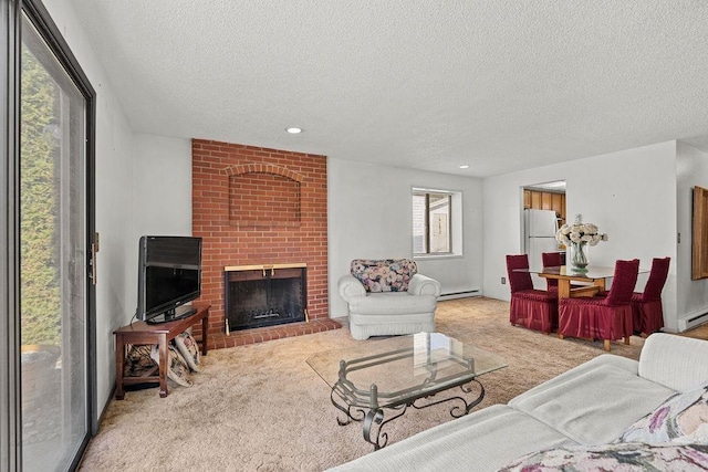 carpeted living area featuring a baseboard heating unit, recessed lighting, a brick fireplace, and a textured ceiling