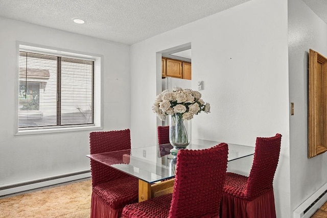 dining space featuring a baseboard radiator, a textured ceiling, and baseboard heating