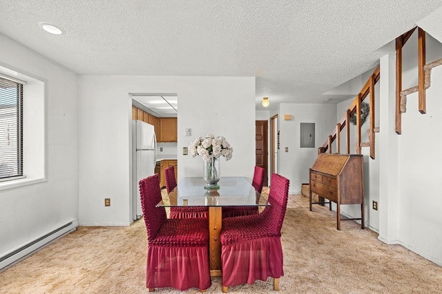 dining space featuring light carpet, electric panel, stairway, and baseboard heating