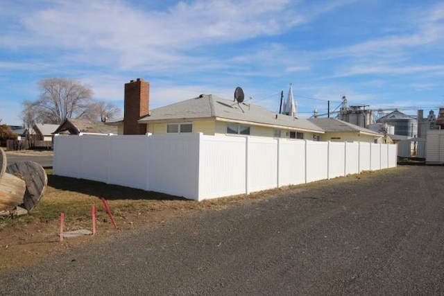 view of home's exterior with fence