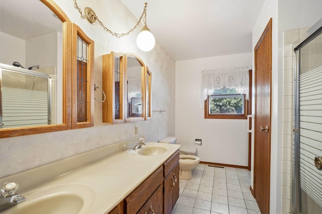 bathroom featuring double vanity, a stall shower, a sink, and visible vents