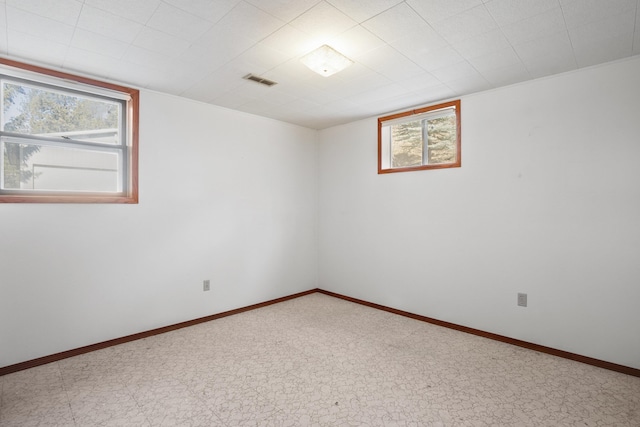 empty room featuring visible vents and baseboards