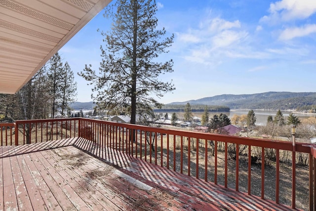 deck with a water and mountain view