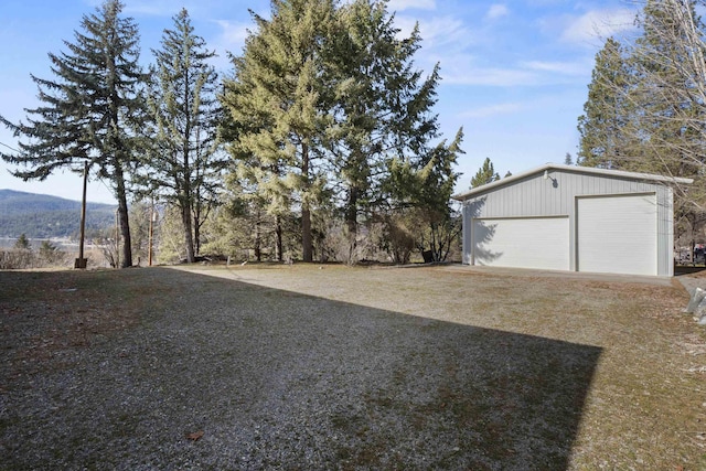 view of yard featuring an outbuilding and a detached garage