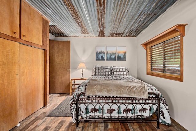 bedroom with wood ceiling and wood finished floors