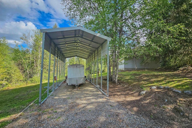 view of vehicle parking with driveway and a detached carport