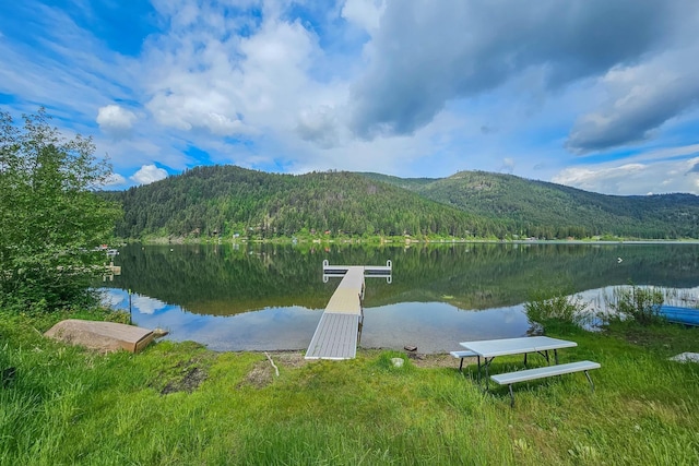 view of dock with a water and mountain view