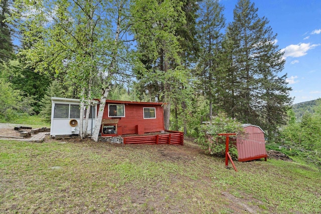 exterior space with an outdoor structure and a lawn