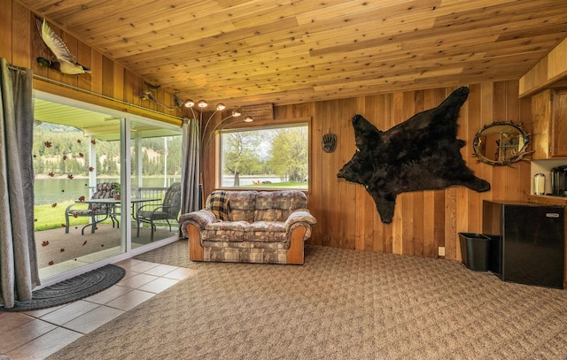 living area featuring wood ceiling, wooden walls, and vaulted ceiling