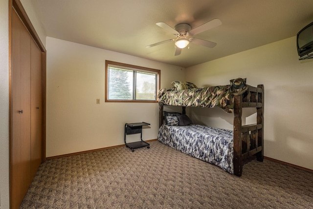 bedroom featuring a ceiling fan, a closet, carpet flooring, and baseboards