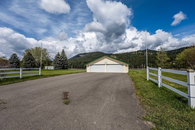 exterior space featuring a front yard, fence, and a mountain view