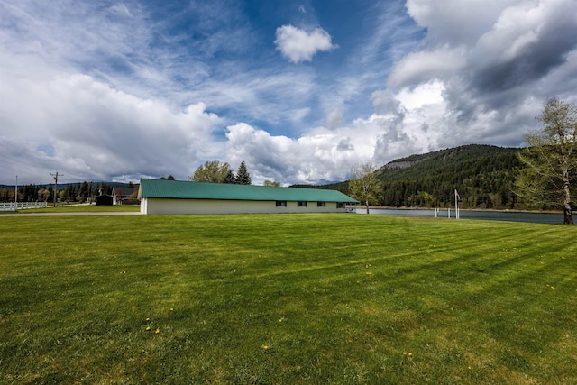 exterior space with a mountain view and a lawn