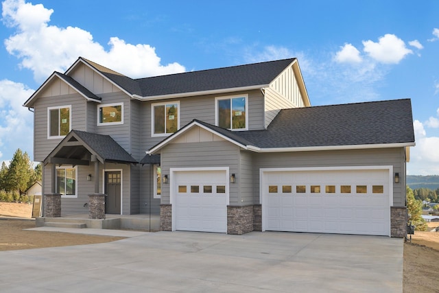 craftsman-style home with board and batten siding, stone siding, and driveway