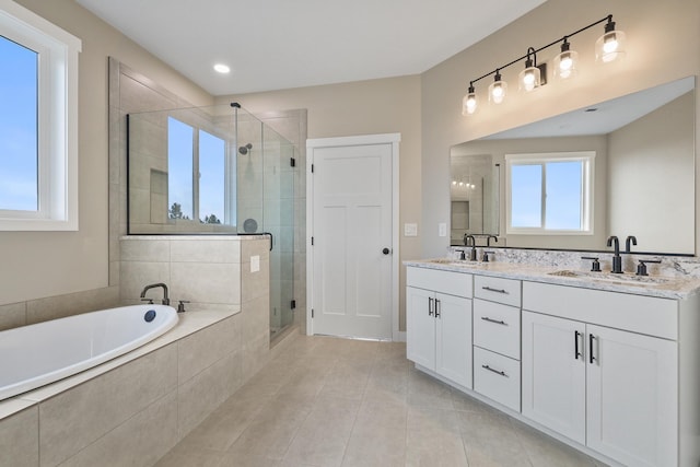 full bathroom with a relaxing tiled tub, a sink, a shower stall, and double vanity