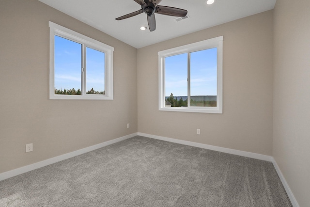 carpeted spare room with ceiling fan, recessed lighting, visible vents, and baseboards