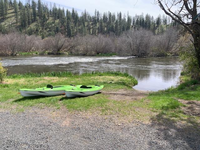 surrounding community featuring a water view and a view of trees