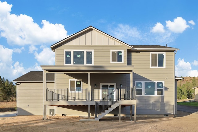 rear view of house featuring stairs, a porch, and board and batten siding