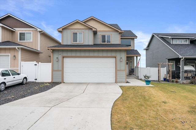 view of front of house with board and batten siding, a front yard, concrete driveway, and fence