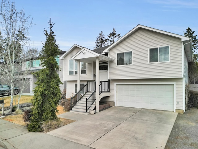 bi-level home with concrete driveway and an attached garage